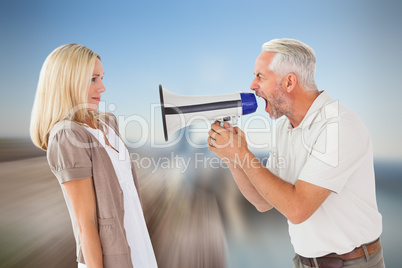 Composite image of angry man shouting at girlfriend through mega