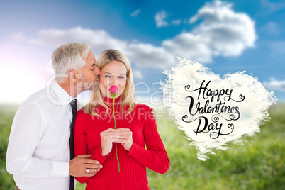 Composite image of handsome man giving his wife a kiss on cheek