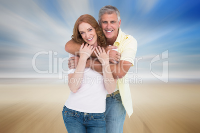 Composite image of casual couple smiling and hugging