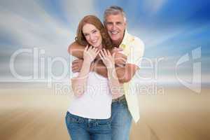 Composite image of casual couple smiling and hugging