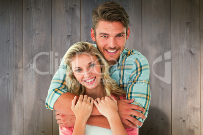 Composite image of attractive young couple smiling at camera