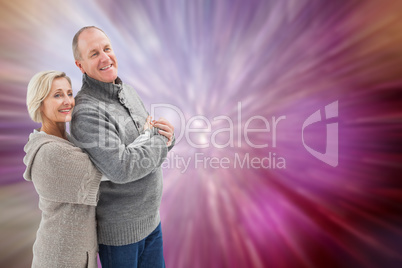 Composite image of happy mature couple in winter clothes