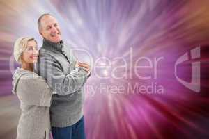 Composite image of happy mature couple in winter clothes