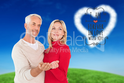 Composite image of happy couple holding their hands out