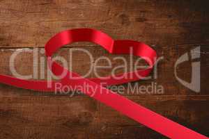 Large red ribbon in a heart shape