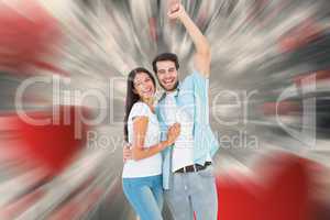 Composite image of happy casual couple cheering at camera