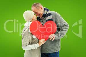 Composite image of happy mature couple in winter clothes holding