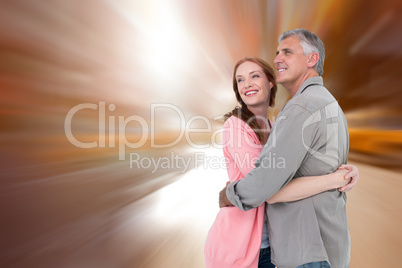 Composite image of casual couple hugging and smiling