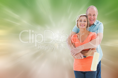 Composite image of happy older couple holding paint roller