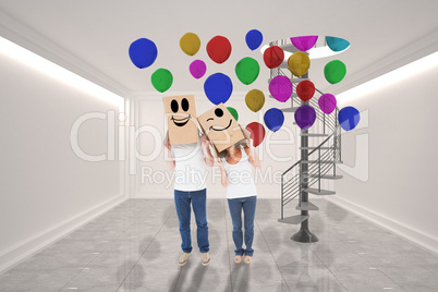 Composite image of mature couple wearing boxes over their heads