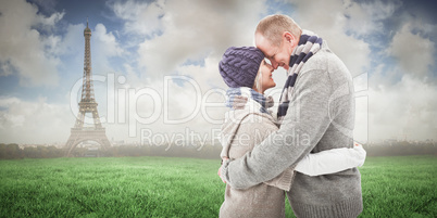 Composite image of happy mature couple in winter clothes hugging