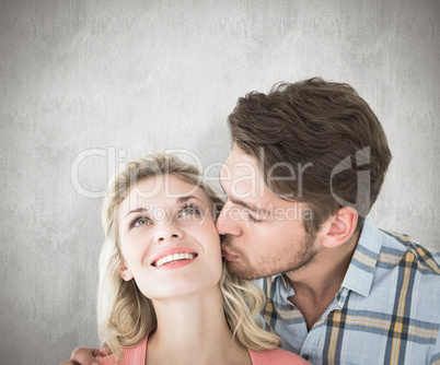 Composite image of handsome man kissing girlfriend on cheek