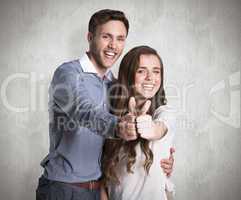 Composite image of happy couple gesturing thumbs up