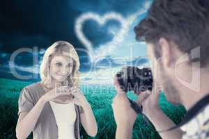 Composite image of man taking photo of his pretty girlfriend