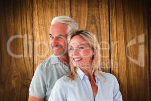 Composite image of happy couple smiling and embracing