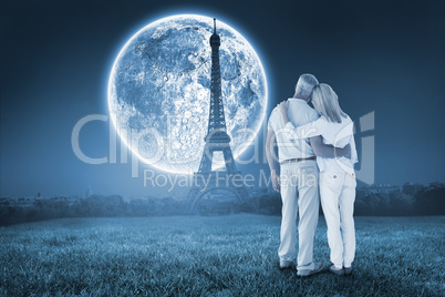 Composite image of happy couple standing and looking