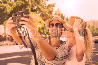 Young hip couple taking a selfie