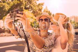 Young hip couple taking a selfie