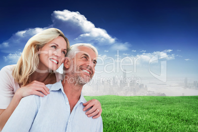 Composite image of smiling couple embracing and looking