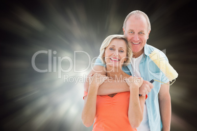 Composite image of happy older couple holding paint roller