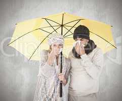 Composite image of couple in winter fashion sneezing under umbre