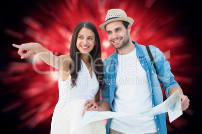 Composite image of happy hipster couple looking at map