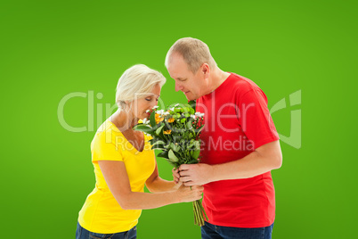 Composite image of mature man offering his partner flowers