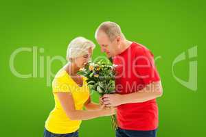 Composite image of mature man offering his partner flowers