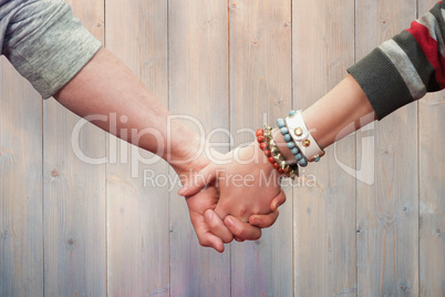 Composite image of students holding hands