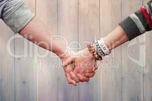 Composite image of students holding hands