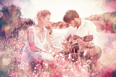 Handsome man serenading his girlfriend with guitar