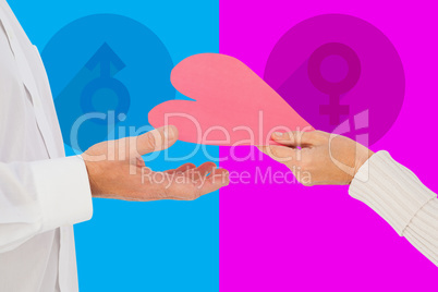 Composite image of woman handing man a paper heart