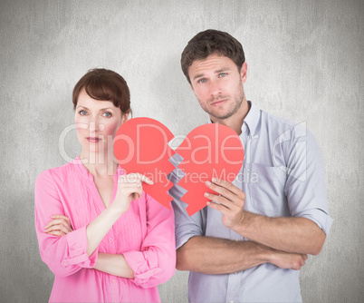 Composite image of couple holding a broken heart