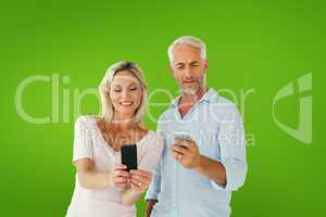 Composite image of happy couple texting on their smartphones