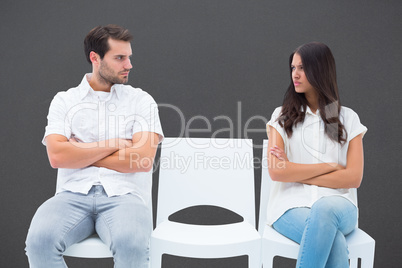 Composite image of angry couple not talking after argument