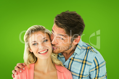 Composite image of handsome man kissing girlfriend on cheek