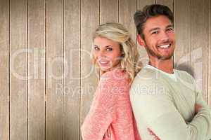 Composite image of attractive couple smiling with arms crossed