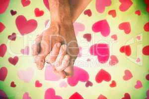 Composite image of happy senior couple holding hands