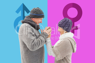 Composite image of happy mature couple in winter clothes embraci