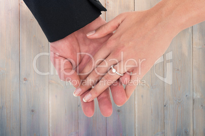 Composite image of close-up of bride and groom with hands togeth