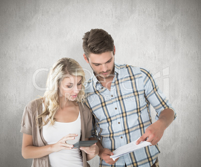 Composite image of attractive couple working out their finances