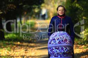 woman with perambulator in the park