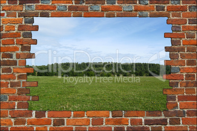 broken brick wall and view to the summer field