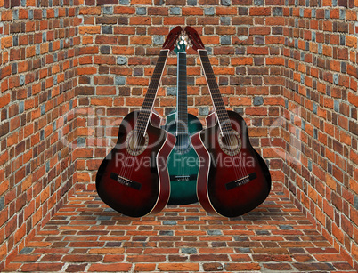 three guitars in the corner of the brick room