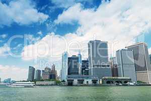 Lower Manhattan skyline with boat crossing river