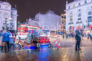 LONDON - SEPTEMBER 27 : Motion blurred traffic and people pass t