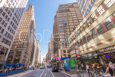 NEW YORK CITY - JUNE 10, 2013: Tourists walk along city avenue.