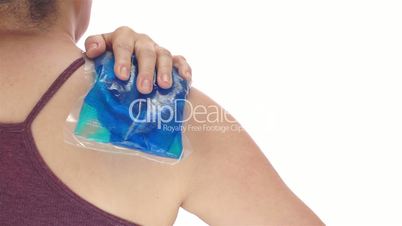 Woman Puts Cold Pack on Shoulder Back View