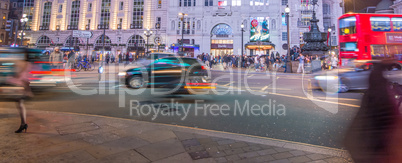 LONDON - SEPTEMBER 27 : Motion blurred traffic and people pass t