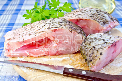 Bream raw with parsley on fabric